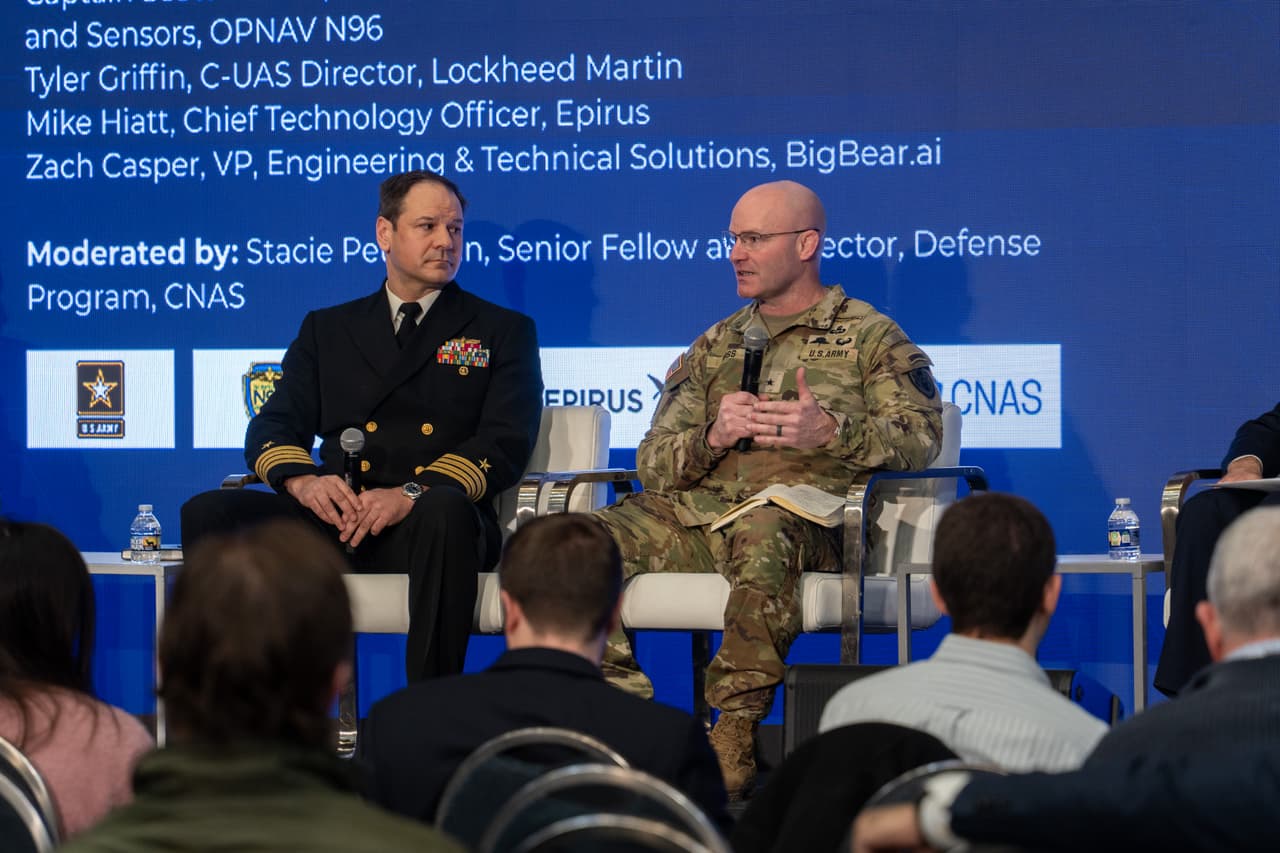 Captain Scott Rosetti (left), the Surface Warfare Deputy Director for Weapons and Sensors at OPNAV N96, and Brigadier General Matthew Ross (right), the Director of JIATF 401, speaking at Apex Defense 2026